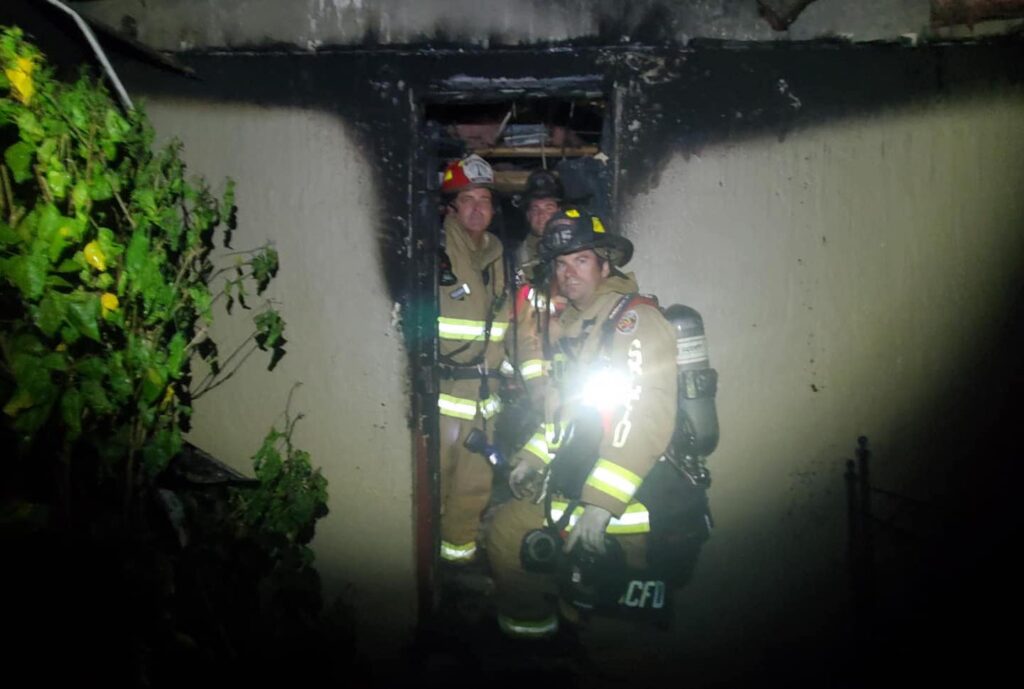 Seminole County Fire Department firefighters exit a home after a fire was extinguished on August 23