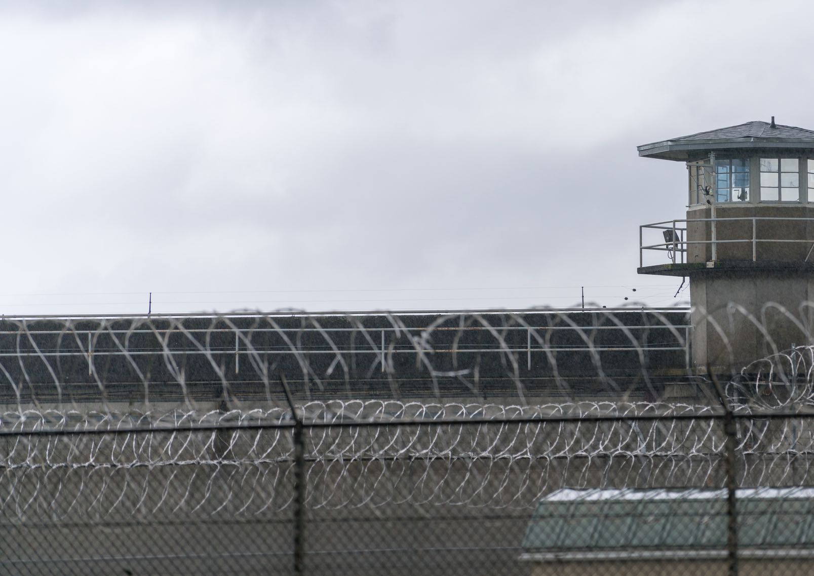 Guard tower barbed wire fence at prison, jail