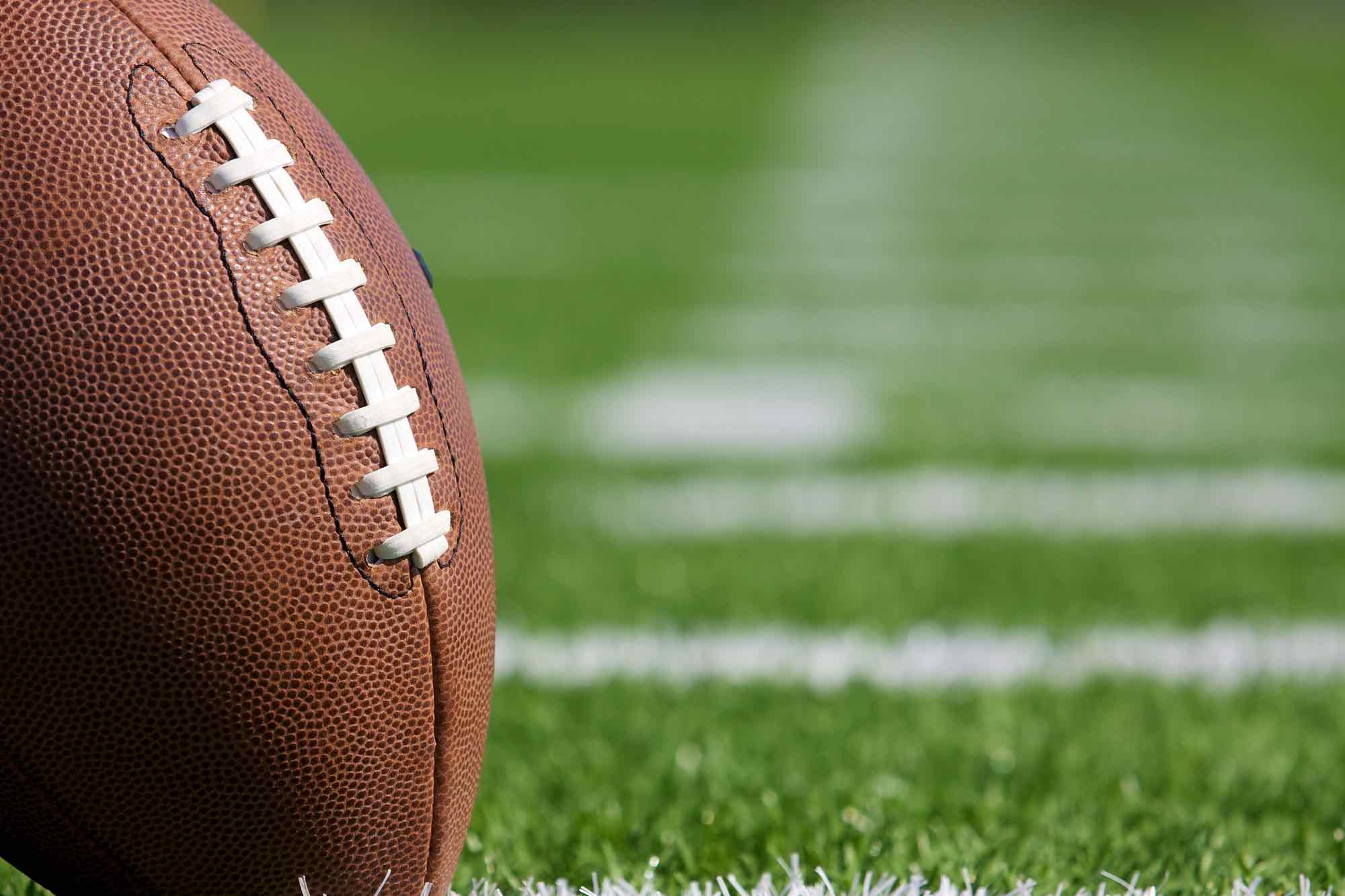 Blurred football on a grass field