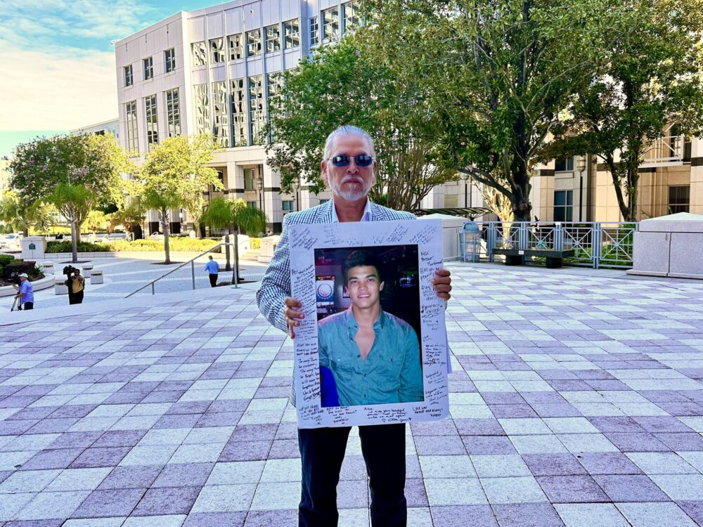 On June 24, 2024, Rafael Zalivar stands in front of the Orange County Courthouse holding a photo of his son, Alex Zaldivar, who was murdered in 2012. (Photo: Office of the State Attorney - 5th Judicial Circuit)